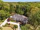 Stunning aerial view of a luxurious home surrounded by lush greenery and a beautifully landscaped yard at 5780 Heards Forest Dr, Atlanta, GA 30328