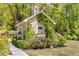 Charming outdoor shed surrounded by lovely landscaping and a lush green lawn at 5780 Heards Forest Dr, Atlanta, GA 30328