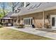 Gorgeous backyard featuring a patio, outdoor seating, lush green lawn, and brick exterior at 5780 Heards Forest Dr, Atlanta, GA 30328