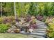 Water feature and beautiful landscaping add tranquility to the backyard and outdoor space at 5780 Heards Forest Dr, Atlanta, GA 30328