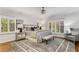 Charming bedroom features natural light from windows with shutters, a decorative chandelier, and neutral decor at 5780 Heards Forest Dr, Atlanta, GA 30328