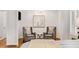 Bedroom features hardwood floors, neutral decor, and a seating area at 5780 Heards Forest Dr, Atlanta, GA 30328