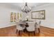 Formal dining room featuring a chandelier, hardwood floors, and natural lighting at 5780 Heards Forest Dr, Atlanta, GA 30328