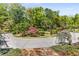 Circular driveway with beautiful landscaping and mature trees enhance the home's curb appeal at 5780 Heards Forest Dr, Atlanta, GA 30328
