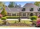 Elegant brick home with manicured lawn, fountain, and flower beds for an inviting curb appeal at 5780 Heards Forest Dr, Atlanta, GA 30328