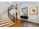 Spacious foyer with curved staircase, chandelier, hardwood floors, and neutral color palette at 5780 Heards Forest Dr, Atlanta, GA 30328