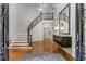 Grand foyer featuring a curved staircase with iron railings and hardwood floors at 5780 Heards Forest Dr, Atlanta, GA 30328