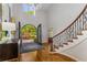 Elegant foyer with dark wood floors, a grand staircase, and custom iron entry doors at 5780 Heards Forest Dr, Atlanta, GA 30328