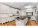 Bright kitchen with a skylight, island, white cabinetry, and stainless steel appliances at 5780 Heards Forest Dr, Atlanta, GA 30328