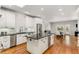 Modern kitchen with white cabinetry, granite countertops, stainless steel appliances, and a central island at 5780 Heards Forest Dr, Atlanta, GA 30328