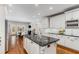 Open kitchen features a center island, granite countertops, and stainless steel appliances at 5780 Heards Forest Dr, Atlanta, GA 30328