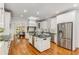 Spacious kitchen boasts a center island, stainless steel appliances, and hardwood flooring at 5780 Heards Forest Dr, Atlanta, GA 30328