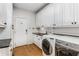 Bright laundry room features modern appliances, custom cabinets, and granite countertop at 5780 Heards Forest Dr, Atlanta, GA 30328
