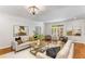 Bright living room with hardwood floors, neutral paint, stylish furnishings, and natural light at 5780 Heards Forest Dr, Atlanta, GA 30328