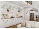 Living room boasts custom built-in shelving, hardwood floors, and neutral decor with views to kitchen at 5780 Heards Forest Dr, Atlanta, GA 30328