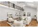 Spacious living room boasts hardwood floors, a fireplace, and a second story balcony with wrought iron at 5780 Heards Forest Dr, Atlanta, GA 30328