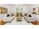 Elegant living room with hardwood floors, neutral tones, a modern chandelier, and plush seating at 5780 Heards Forest Dr, Atlanta, GA 30328