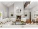 Bright living room features a fireplace with decorative mantle, hardwood floors, and plush seating at 5780 Heards Forest Dr, Atlanta, GA 30328
