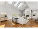 Bright living room with vaulted ceiling, skylights, fireplace, and hardwood floors at 5780 Heards Forest Dr, Atlanta, GA 30328