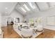 Light-filled living room with hardwood floors, high ceilings, and an abundance of natural light from skylights at 5780 Heards Forest Dr, Atlanta, GA 30328