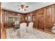 Wood-paneled office with hardwood floors, plantation shutters, and a decorative ceiling fan at 5780 Heards Forest Dr, Atlanta, GA 30328