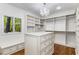 Spacious walk-in closet featuring custom shelving and a center island with drawers at 5780 Heards Forest Dr, Atlanta, GA 30328
