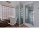 Bathroom featuring a glass block wall, tiled shower, and comfortable seating at 6 Lullwater Ne Est, Atlanta, GA 30307
