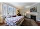Comfortable bedroom with large windows, providing plenty of natural light and a cozy fireplace at 6 Lullwater Ne Est, Atlanta, GA 30307