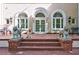 Charming front porch with dog statues and a happy Labrador Retriever at 6 Lullwater Ne Est, Atlanta, GA 30307