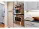 Modern kitchen featuring built-in stainless steel double ovens and sleek cabinetry at 6 Lullwater Ne Est, Atlanta, GA 30307