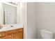 Bright bathroom with white countertop, wood cabinets, and a large mirror at 69 Eagle Glen Dr, Cartersville, GA 30121