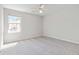Bright bedroom featuring neutral carpet, a ceiling fan, and a window providing ample natural light at 69 Eagle Glen Dr, Cartersville, GA 30121