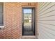 Close-up of the front door with clear glass; showing the house across the street at 69 Eagle Glen Dr, Cartersville, GA 30121