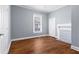 This bedroom features hardwood floors, a window and white trim at 135 Adair Se Ave, Atlanta, GA 30315