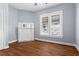 Bedroom with white trim, hardwood floors and a decorative fireplace at 135 Adair Se Ave, Atlanta, GA 30315