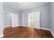 Bedroom with hardwood floors offering entrances to another room and an en-suite bathroom at 135 Adair Se Ave, Atlanta, GA 30315