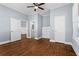 Main bedroom with hardwood floors, neutral walls, ceiling fan, and an en-suite bathroom at 135 Adair Se Ave, Atlanta, GA 30315
