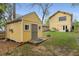 Landscaped backyard view featuring a two-story home and a matching storage shed at 357 Murray Hill Ne Ave, Atlanta, GA 30317