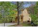 Side view of a yellow two-story home with a well-maintained lawn and attached two-car garage at 357 Murray Hill Ne Ave, Atlanta, GA 30317