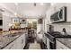 This kitchen features stainless steel appliances, white cabinets, and a dining area by the windows at 357 Murray Hill Ne Ave, Atlanta, GA 30317