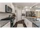 Bright kitchen featuring stainless steel appliances, white cabinets, and a granite countertop at 357 Murray Hill Ne Ave, Atlanta, GA 30317