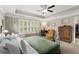 Well-lit main bedroom with tray ceilings and a view to an accessible en-suite bathroom at 357 Murray Hill Ne Ave, Atlanta, GA 30317