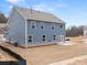 Home backyard with blue siding, patio, and a spacious yard at 7181 Linden Dr, South Fulton, GA 30349