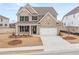 Charming brick home featuring a two-car garage, manicured lawn, and inviting front porch at 7181 Linden Dr, South Fulton, GA 30349