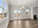 Open-concept living room boasts hardwood flooring, natural light, and a charming fireplace at 7181 Linden Dr, South Fulton, GA 30349