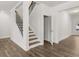 Elegant staircase with stained treads, white risers and black iron balusters at 7181 Linden Dr, South Fulton, GA 30349