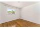 Empty bedroom featuring hardwood floors and natural light from window at 2315 Shamrock Dr, Decatur, GA 30032