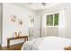 Sunlit bedroom with bench seat, hardwood floors, and view to attached bath at 2315 Shamrock Dr, Decatur, GA 30032