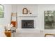 Elegant fireplace with white brick surround, wooden mantle, and decorative accents at 2315 Shamrock Dr, Decatur, GA 30032
