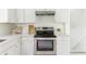 Bright kitchen features stainless steel oven, modern white cabinets, and stone countertops at 2315 Shamrock Dr, Decatur, GA 30032